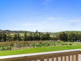 A view of green hills and trees at Over the Paddock - Waipu