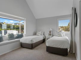 A bedroom with two beds and a lamp at Hampton Cottage by the Lake - Taupo Central