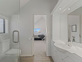 A bathroom with a shower and sink at Hampton Cottage by the Lake - Taupo Central