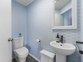 A bathroom with a toilet and sink at Hampton Cottage by the Lake - Taupo Holiday Home Taupo Central