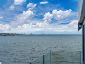A view of water with mountains and clouds at Hampton Cottage by the Lake - Taupo Central