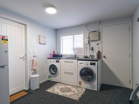 A laundry room with washing machine and dryer at Hampton Cottage by the Lake - Taupo Central
