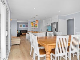 A dining room with a table and chairs at Waipu Hilltop Escape - Waipu Cove