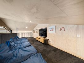 A loft with bean bags and a tv unit at Waipu Hilltop Escape - Waipu Cove
