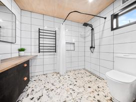 A bathroom with shower, toilet and sink at Waipu Hilltop Escape - Waipu Cove