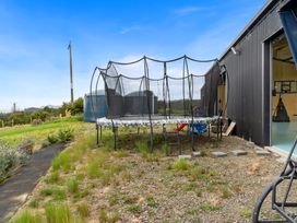 An outdoor area with a trampoline and a water tank at Waipu Hilltop Escape - Waipu Cove