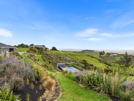 An outdoor view of a garden with a pool at Waipu Hilltop Escape - Waipu Cove