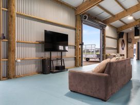 A living room with a television and sofa at Waipu Hilltop Escape - Waipu Cove