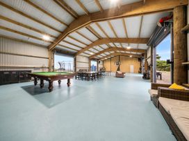 A recreation room with a pool table and dining table at Waipu Hilltop Escape - Waipu Cove