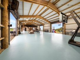 A recreation area with a basketball hoop and tables at Waipu Hilltop Escape - Waipu Cove