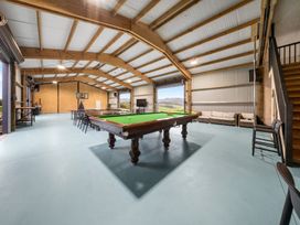 A recreation room with a pool table and seating at Waipu Hilltop Escape - Waipu Cove