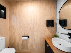 A bathroom with a toilet and sink at Waipu Hilltop Escape - Waipu Cove
