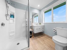 A bathroom with a shower and sink at Waipu Hilltop Escape - Waipu Cove