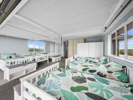 A bedroom with multiple beds at Waipu Hilltop Escape - Waipu Cove