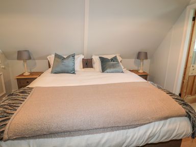A bedroom with a double bed two bedside tables and lamps at Fenwick Retreat at Fenwick Lodge Fenwick near Ponteland