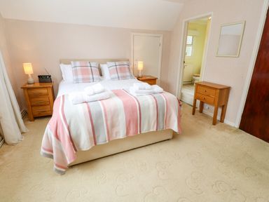 A bedroom with a double bed and bedside tables with lamps at Trevow in Camborne