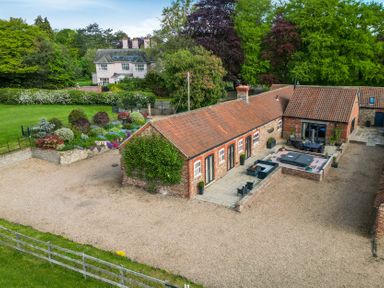 An outdoor area with a building and garden at Sykes Lodge in Malton
