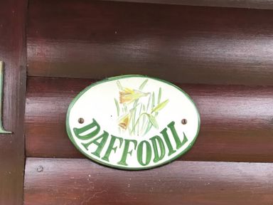 A sign with the word Daffodil and a floral design at Daffodil Lodge in Saltburn-by-the-Sea