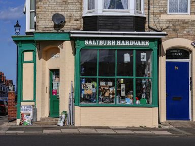 A hardware store with green windows and signage at Daffodil Lodge in Saltburn-by-the-Sea