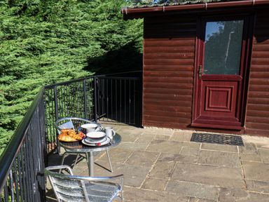 An outdoor patio with a table and chairs at Orchid Lodge in Saltburn-by-the-Sea