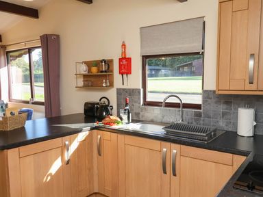 A kitchen with sink and window at Orchid Lodge Saltburn-by-the-Sea