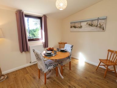A dining room with a table and chairs at Orchid Lodge Saltburn-by-the-Sea