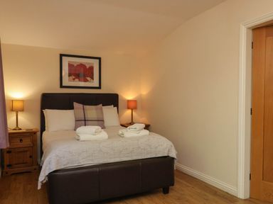 A bedroom with a bed and bedside tables at Orchid Lodge Saltburn-by-the-Sea