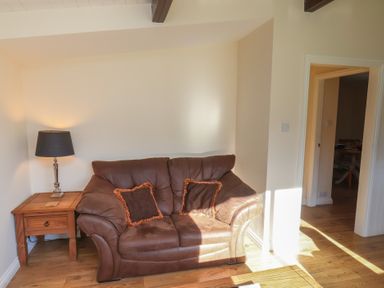 A living room with a sofa and lamp at Foxglove Lodge Saltburn-By-The-Sea