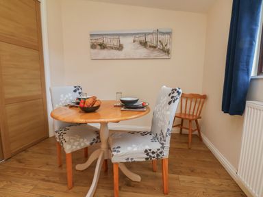 A dining room with a table and two chairs at Foxglove Lodge in Saltburn-By-The-Sea