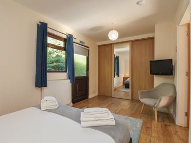 A bedroom with a bed and television at Foxglove Lodge in Saltburn-By-The-Sea