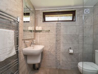 A bathroom with a sink and toilet at Foxglove Lodge in Saltburn-By-The-Sea