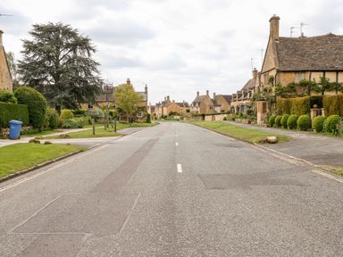 A street with stone houses and green hedges on both sides at The Cottage at Broadway in Broadway