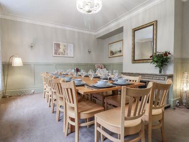 A dining room with a large table set for a meal at The Manor House in Scarborough