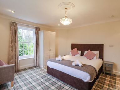A bedroom with a bed and wardrobe at The Manor House in Scarborough
