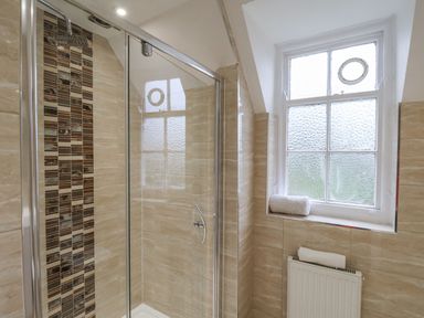 A bathroom with a shower and a window at The Manor House in Scarborough