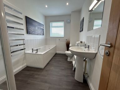 A bathroom with a bathtub a sink a toilet and a window at Willow Retallack in Retallack near St Columb Major