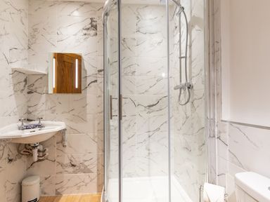 A bathroom with a sink mirror shower and toilet at Bayview Terrace in Lynton
