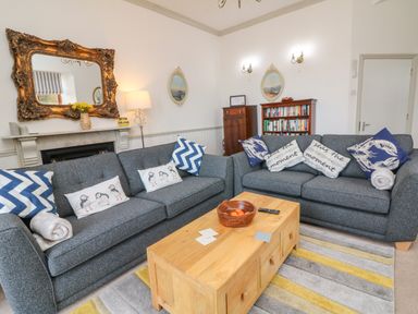 A living room with two grey sofas cushions and a wooden coffee table at Bayview Terrace in Lynton
