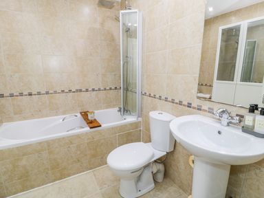 A bathroom with a bathtub shower toilet and sink at Horeb Chapel House in Tanygrisiau