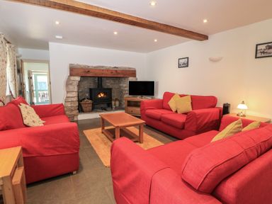 A living room with sofas and a fireplace at Dale Barton in Wells