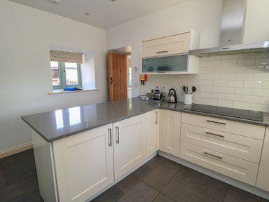 A kitchen with countertop, kettle, and cabinets at Dale Barton in Wells