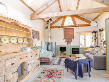 A living room with wooden beams rugs and sofas at Little Willow in Farrington near Child Okeford