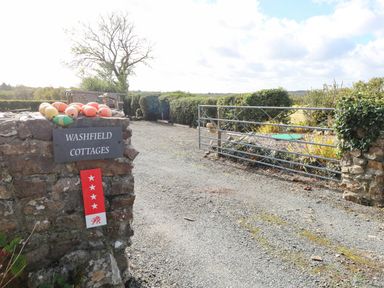 An entrance with a sign and gate at Washfield Cottages near Narberth