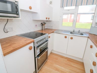 A kitchen with wooden countertops a stove a sink and a window at The Borrowers in Dartmouth