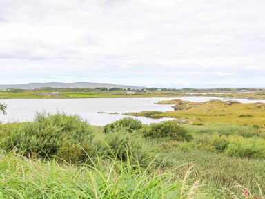 A landscape with water bodies and green vegetation at The Mermaid in Dungloe County Donegal