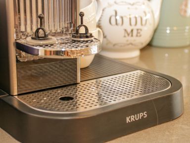 A close up of a Krups coffee machine on a kitchen counter with mugs in the background at Penholm in Penmaenmawr