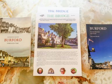 Three publications about Burford placed on a marble surface