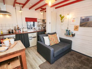 A kitchen with a sofa and wooden counter at Grain Store near Narberth