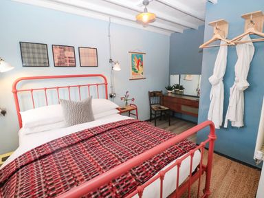 A bedroom with a bed and mirror at Grain Store near Narberth