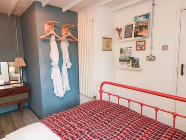 A bedroom with a bed and decorative items at Grain Store near Narberth
